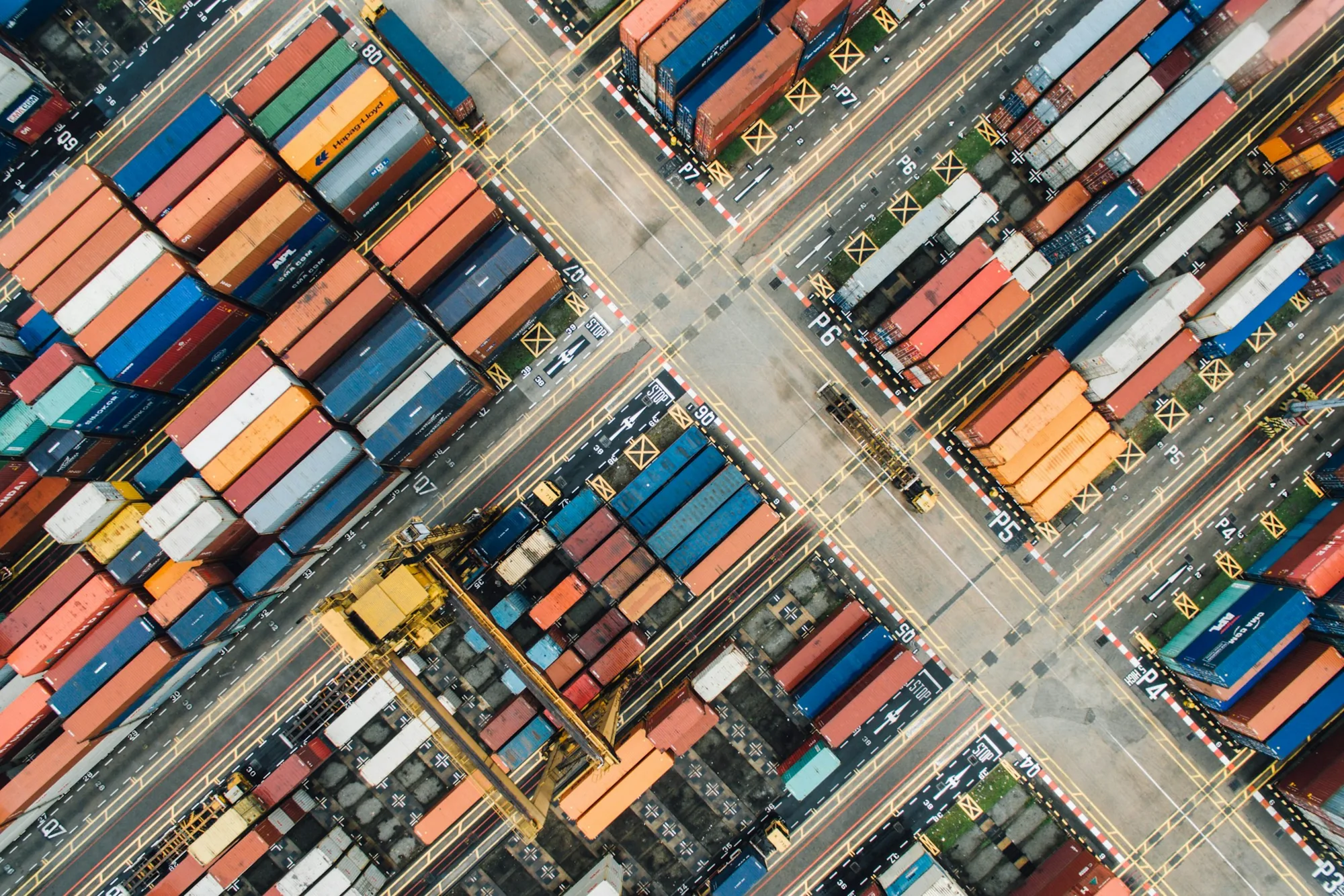 Overhead view of containers and transport lanes at a cargo terminal